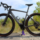 A photo of a Specialized Creo SL electric bike half on a dirt track and half on paving.